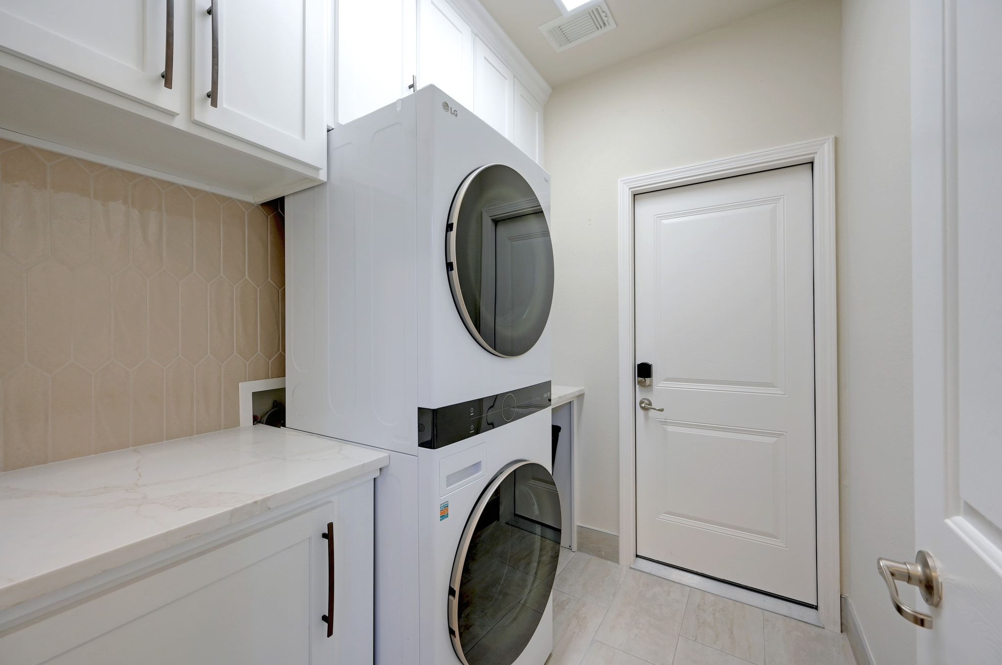 7112 Via Correto Drive Austin, TX 78749 - Photo 15 of 29 Laundry area with stacked washer / drying machine and cabinet space