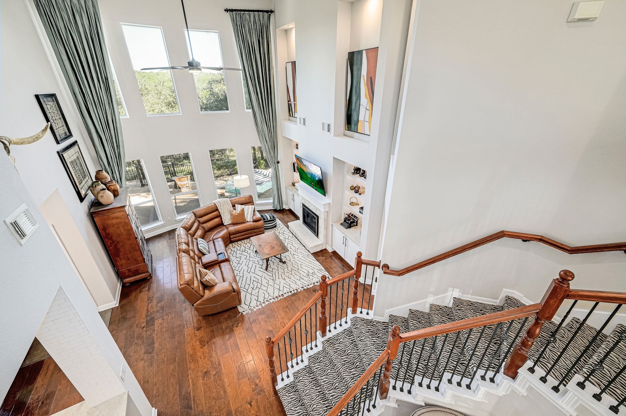 7112 Via Correto Drive Austin, TX 78749 - Photo 17 of 29 Living area featuring a fireplace, a high ceiling, and hardwood / wood floors