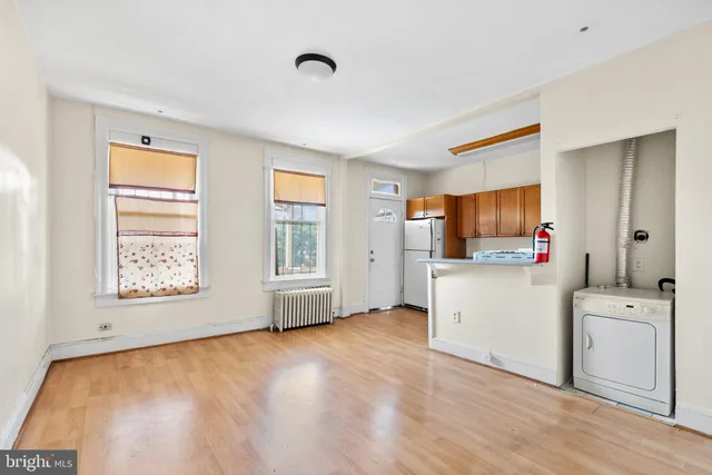a view of kitchen and bathroom with wooden floor