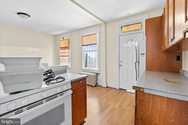 a kitchen view with wooden floor washer and dryer