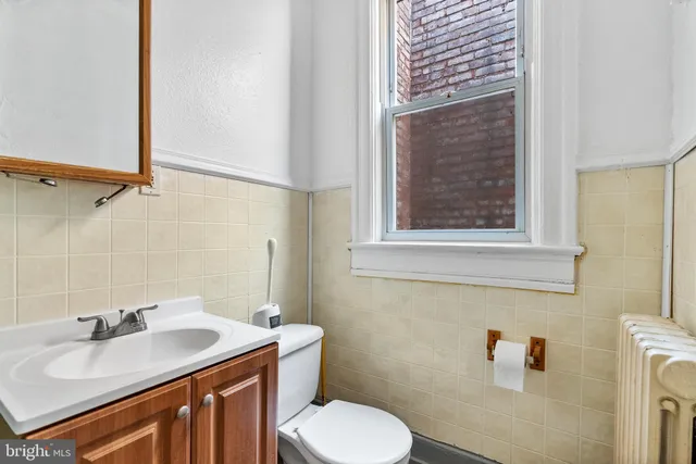a bathroom with a sink toilet and vanity