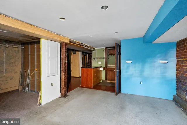a bathroom with a toilet mirror and sink