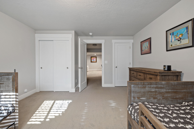 2745 Red Barn Road South Heber City, UT 84032 - Photo 34 of 51 Bedroom with light colored carpet, multiple closets, and a textured ceiling