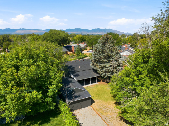 1187 East Ridgedale Circle Millcreek, UT 84106 - Photo 44 of 49 Aerial property view featuring a dark-toned roof, a covered patio area, and a detached garage with a matching roofline
