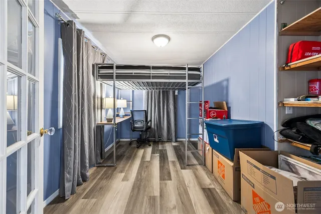a storage room with wooden floor and furniture