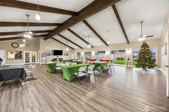 a dining room with furniture entryway and wooden floor