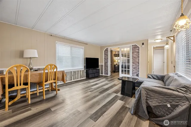 a living room with furniture ceiling fan and a window