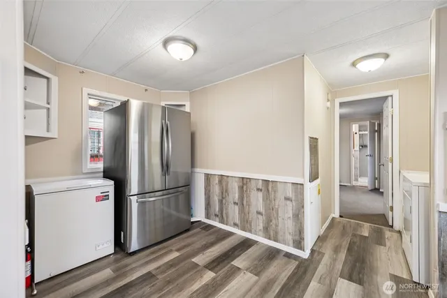 a view of a refrigerator in kitchen and wooden floor