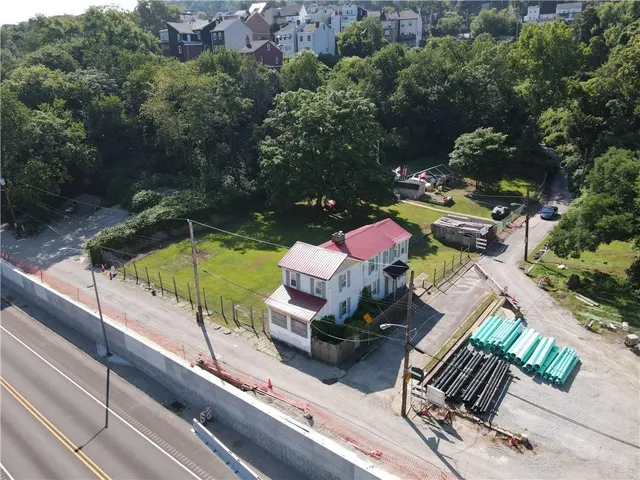 an aerial view of a house with a garden and pool