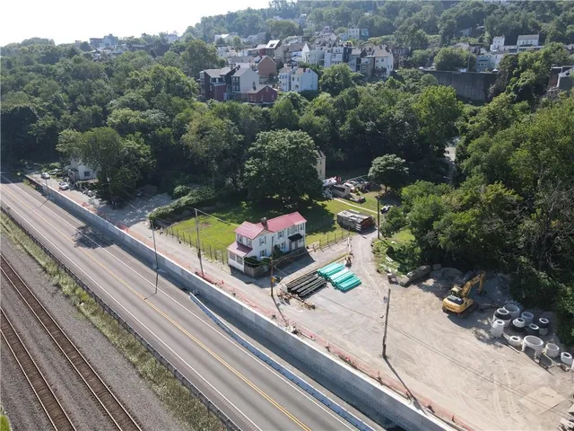 an aerial view of a residential houses with yard