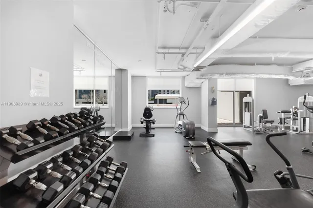 a room with gym equipment and a large window