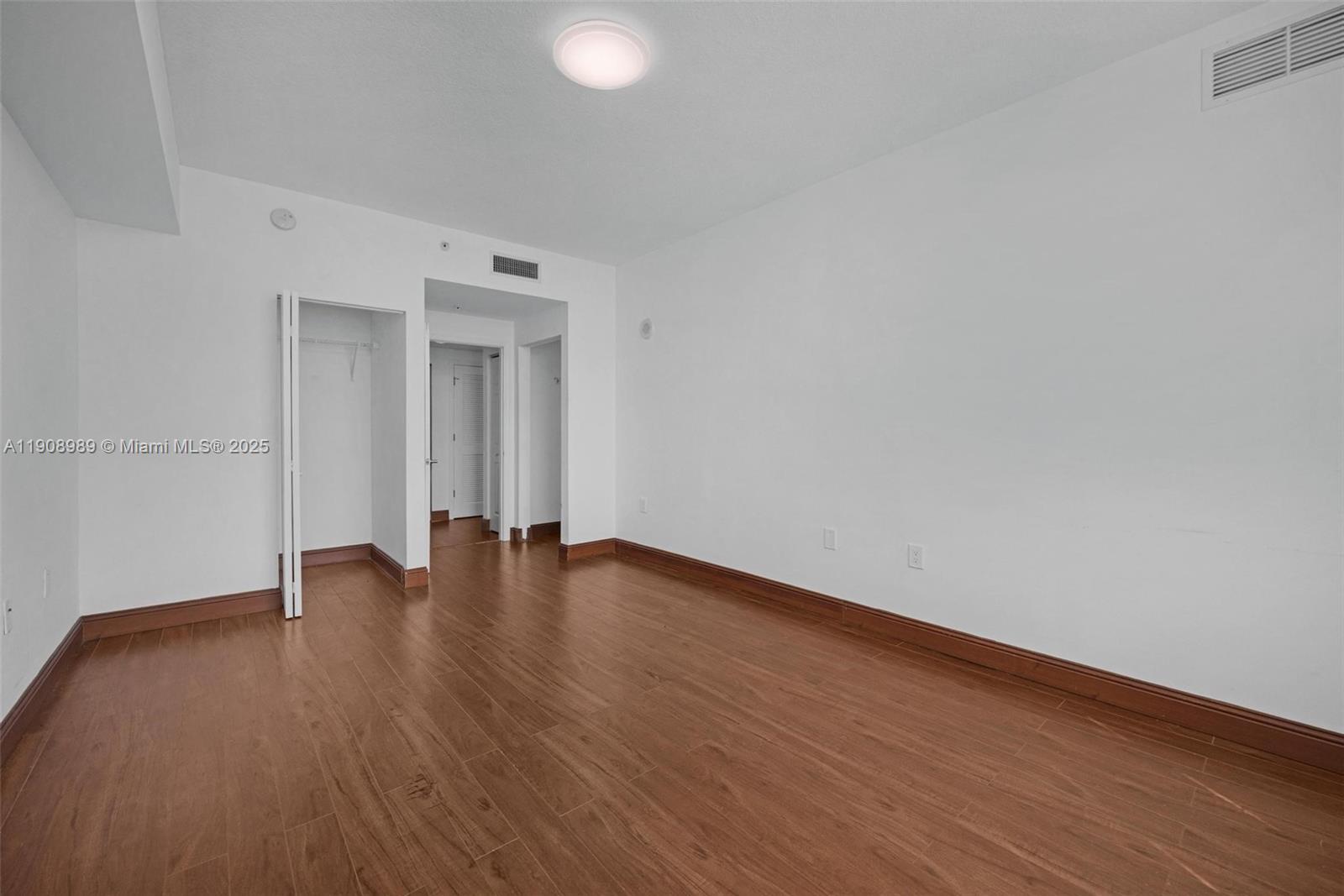 140 South Dixie Highway, Unit 533 Hollywood, FL 33020 - Photo 9 of 17 a view of an empty room with wooden floor and a window