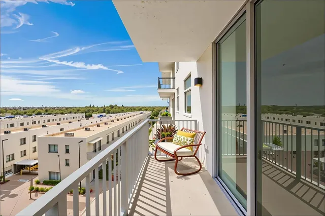 a balcony with an outdoor seating