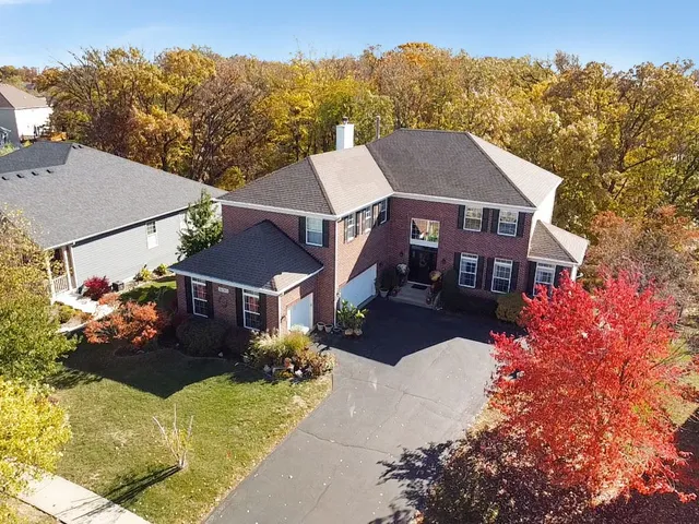 a aerial view of a house with a yard and a garden