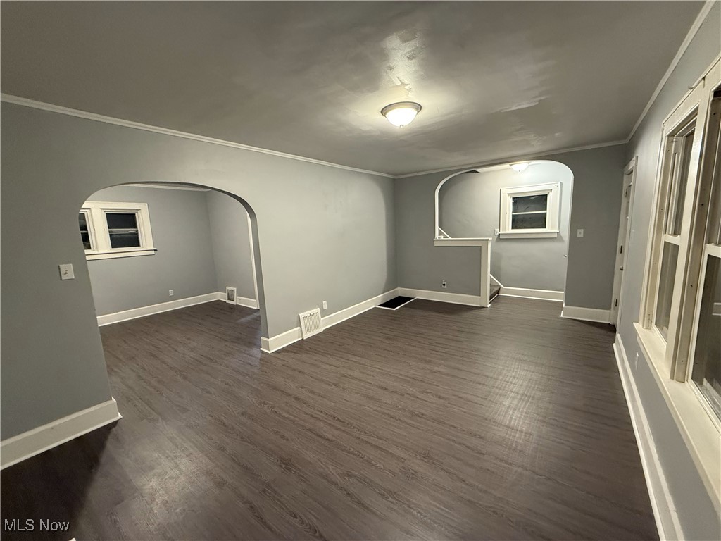 1013 Berwin Street Akron, OH 44310 - Photo 4 of 13 Unfurnished room with crown molding and dark wood-type flooring