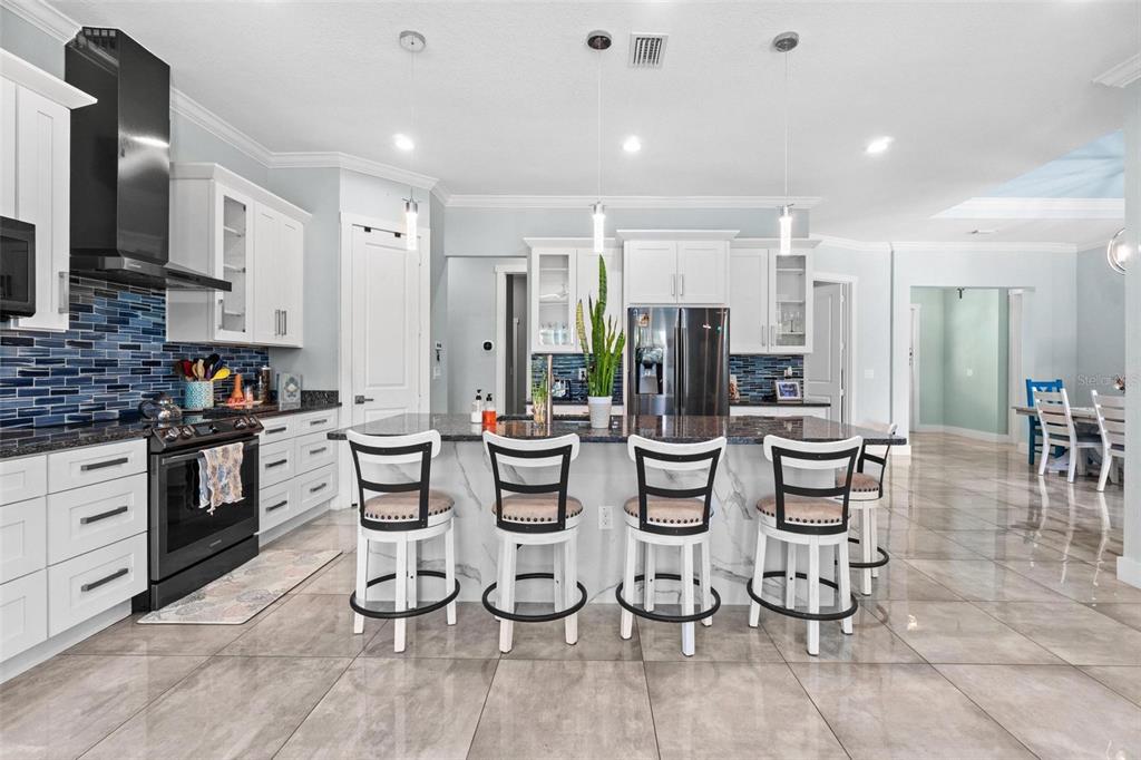 716 Laurel Avenue Venice, FL 34285 - Photo 11 of 42 a large kitchen with a table and chairs