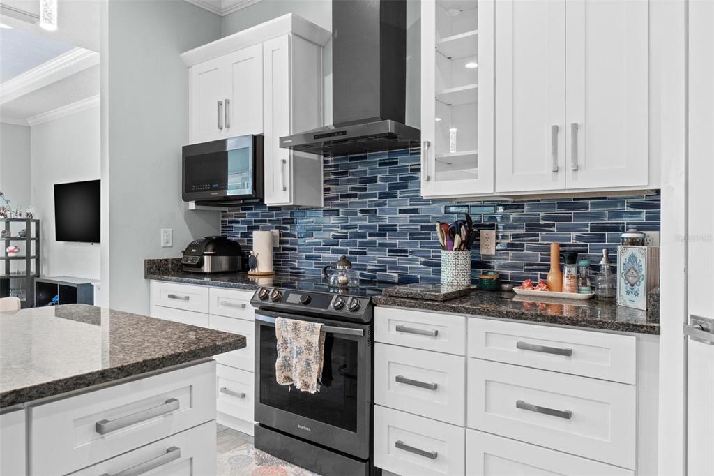 716 Laurel Avenue Venice, FL 34285 - Photo 12 of 42 a kitchen with granite countertop a sink stove and cabinets
