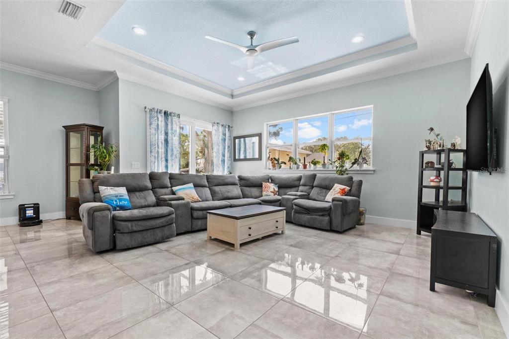 716 Laurel Avenue Venice, FL 34285 - Photo 17 of 42 a living room with furniture a desk and a flat screen tv