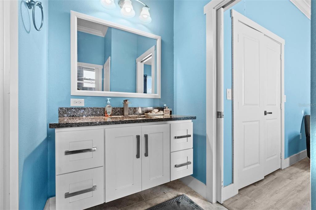 716 Laurel Avenue Venice, FL 34285 - Photo 24 of 42 a bathroom with a granite countertop sink and a mirror