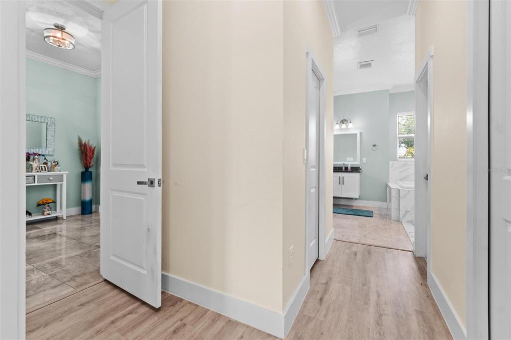 716 Laurel Avenue Venice, FL 34285 - Photo 31 of 42 a view of a hallway with bathroom and wooden floor