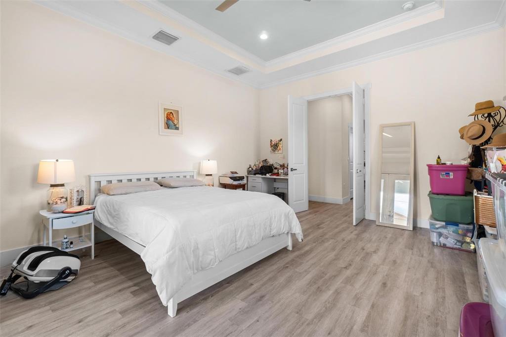 716 Laurel Avenue Venice, FL 34285 - Photo 33 of 42 a spacious bedroom with a bed and wooden floor