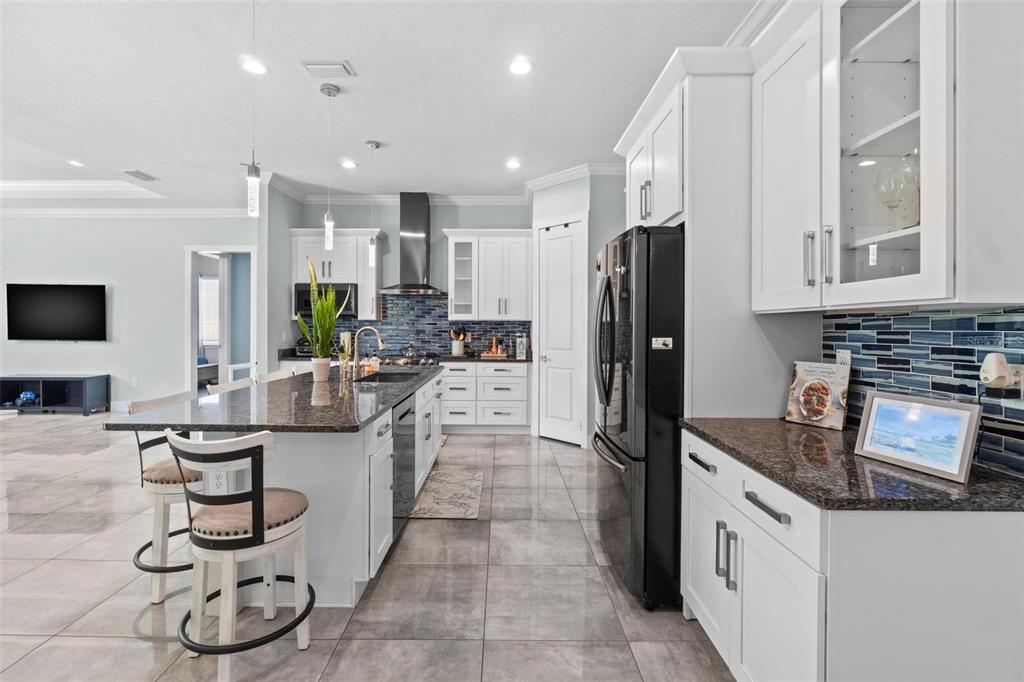 716 Laurel Avenue Venice, FL 34285 - Photo 9 of 42 a kitchen with stainless steel appliances granite countertop a sink refrigerator and cabinets