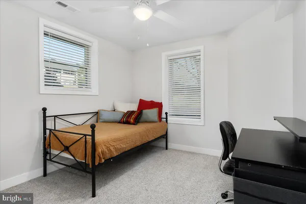 a bedroom with a bed and a chair