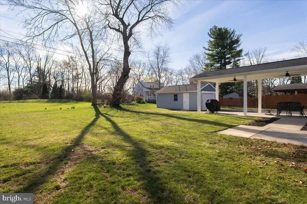 a view of a house with pool and sitting area