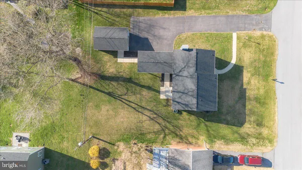an aerial view of a house with a yard