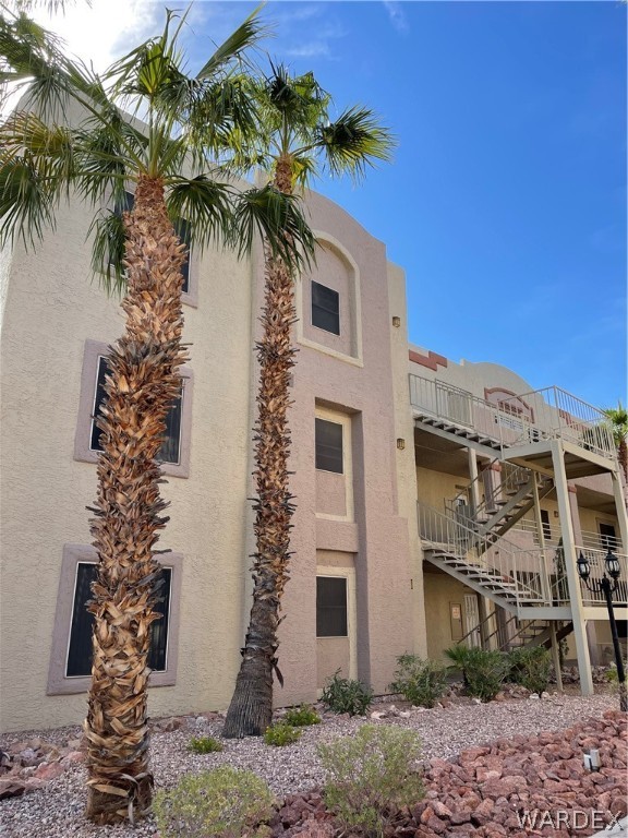 2052 Mesquite Lane, Unit 101 Laughlin, NV 89029 - Photo 1 of 32 a plant that is in front of a white house