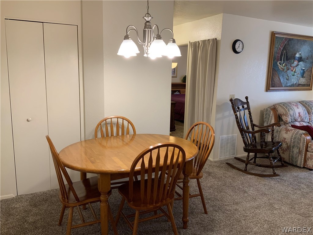 2052 Mesquite Lane, Unit 101 Laughlin, NV 89029 - Photo 11 of 32 a view of a dining room with furniture and chandelier