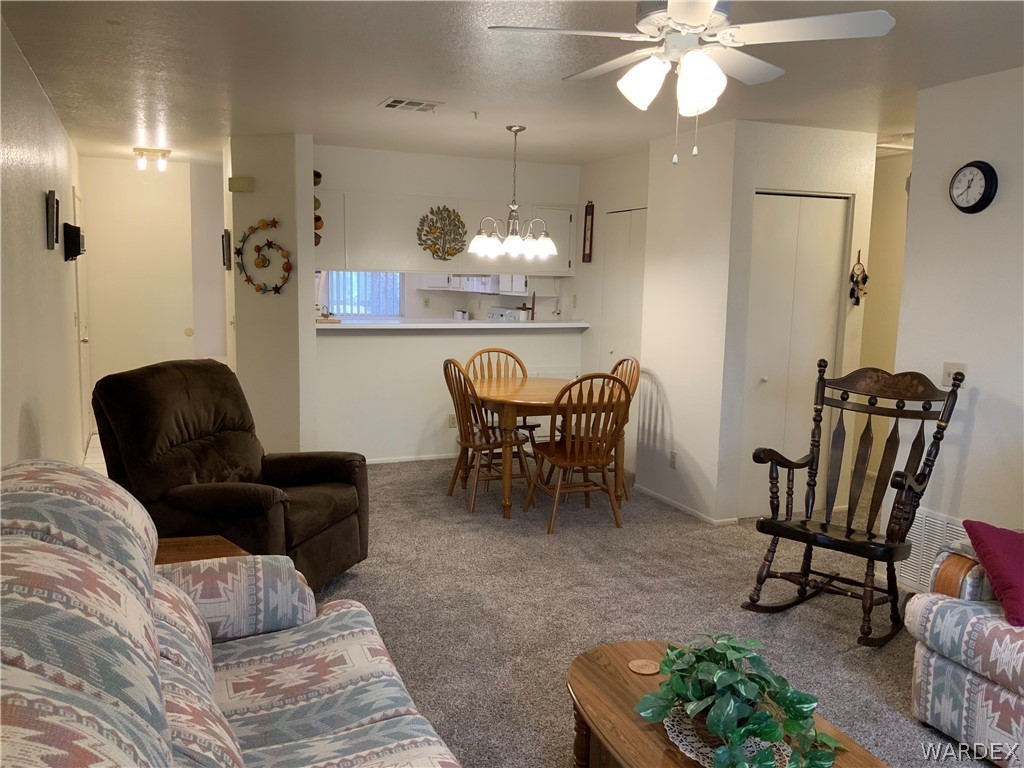 2052 Mesquite Lane, Unit 101 Laughlin, NV 89029 - Photo 15 of 32 a dining room with furniture and a chandelier