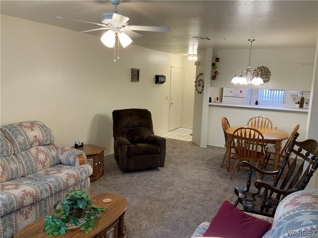 2052 Mesquite Lane, Unit 101 Laughlin, NV 89029 - Photo 16 of 32 a living room with furniture and a chandelier