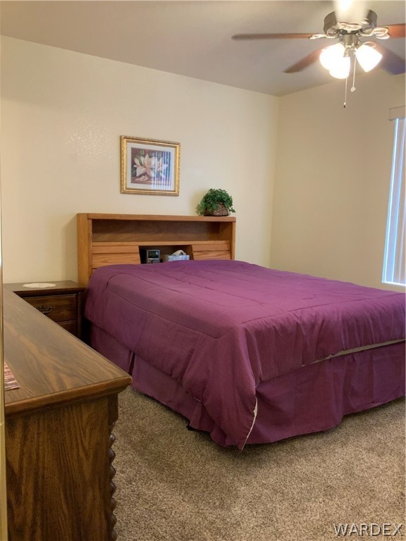2052 Mesquite Lane, Unit 101 Laughlin, NV 89029 - Photo 19 of 32 a bedroom with a bed and a chandelier