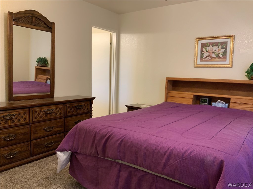 2052 Mesquite Lane, Unit 101 Laughlin, NV 89029 - Photo 20 of 32 a bedroom with a bed and a dresser