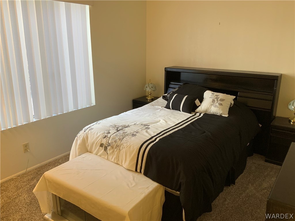 2052 Mesquite Lane, Unit 101 Laughlin, NV 89029 - Photo 24 of 32 a bed sitting in a bedroom next to a window