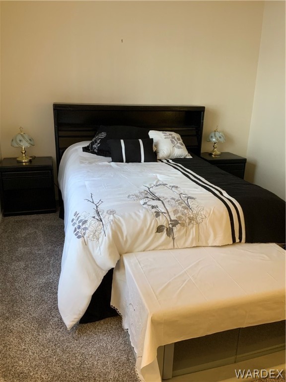 2052 Mesquite Lane, Unit 101 Laughlin, NV 89029 - Photo 25 of 32 a bedroom with a bed and a night stand