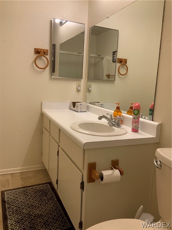 2052 Mesquite Lane, Unit 101 Laughlin, NV 89029 - Photo 29 of 32 a bathroom with a sink a toilet and mirror