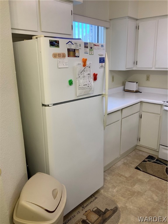 2052 Mesquite Lane, Unit 101 Laughlin, NV 89029 - Photo 6 of 32 a white refrigerator freezer sitting in a kitchen