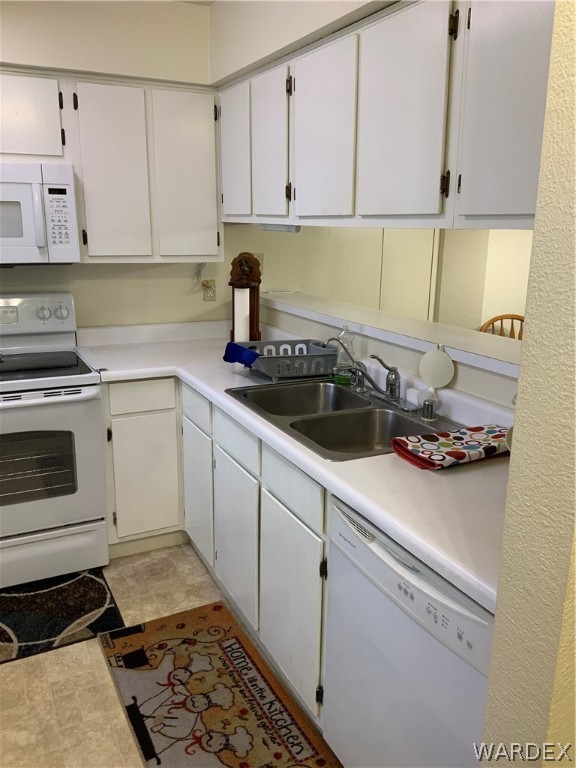 2052 Mesquite Lane, Unit 101 Laughlin, NV 89029 - Photo 8 of 32 a kitchen with a stove and white cabinets