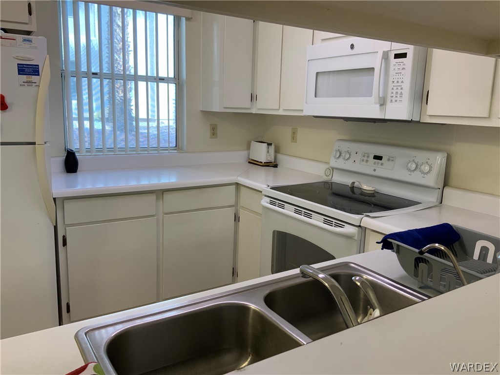 2052 Mesquite Lane, Unit 101 Laughlin, NV 89029 - Photo 9 of 32 a kitchen that has a sink and cabinets