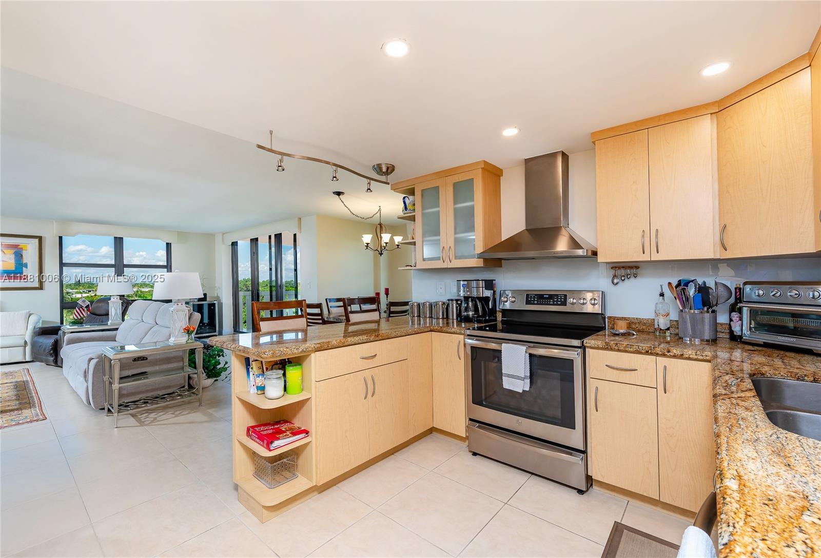 1121 Crandon Boulevard, Unit E501 Key Biscayne, FL 33149 - Photo 13 of 44 a kitchen with a sink stove and cabinets