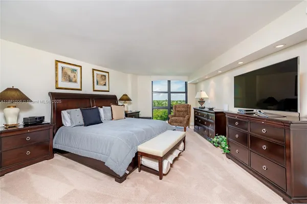 a bedroom with a bed and dresser with window