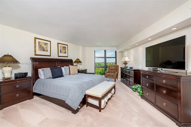 a bedroom with a bed and dresser with window