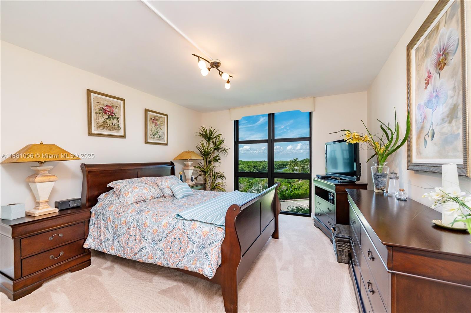 1121 Crandon Boulevard, Unit E501 Key Biscayne, FL 33149 - Photo 22 of 44 a bedroom with a bed and a dresser next to a window