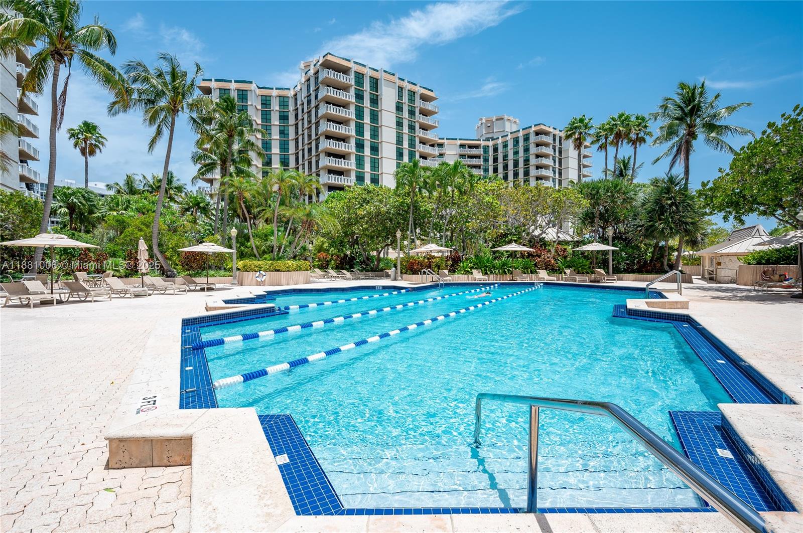 1121 Crandon Boulevard, Unit E501 Key Biscayne, FL 33149 - Photo 28 of 44 a view of a swimming pool with a yard and sitting area