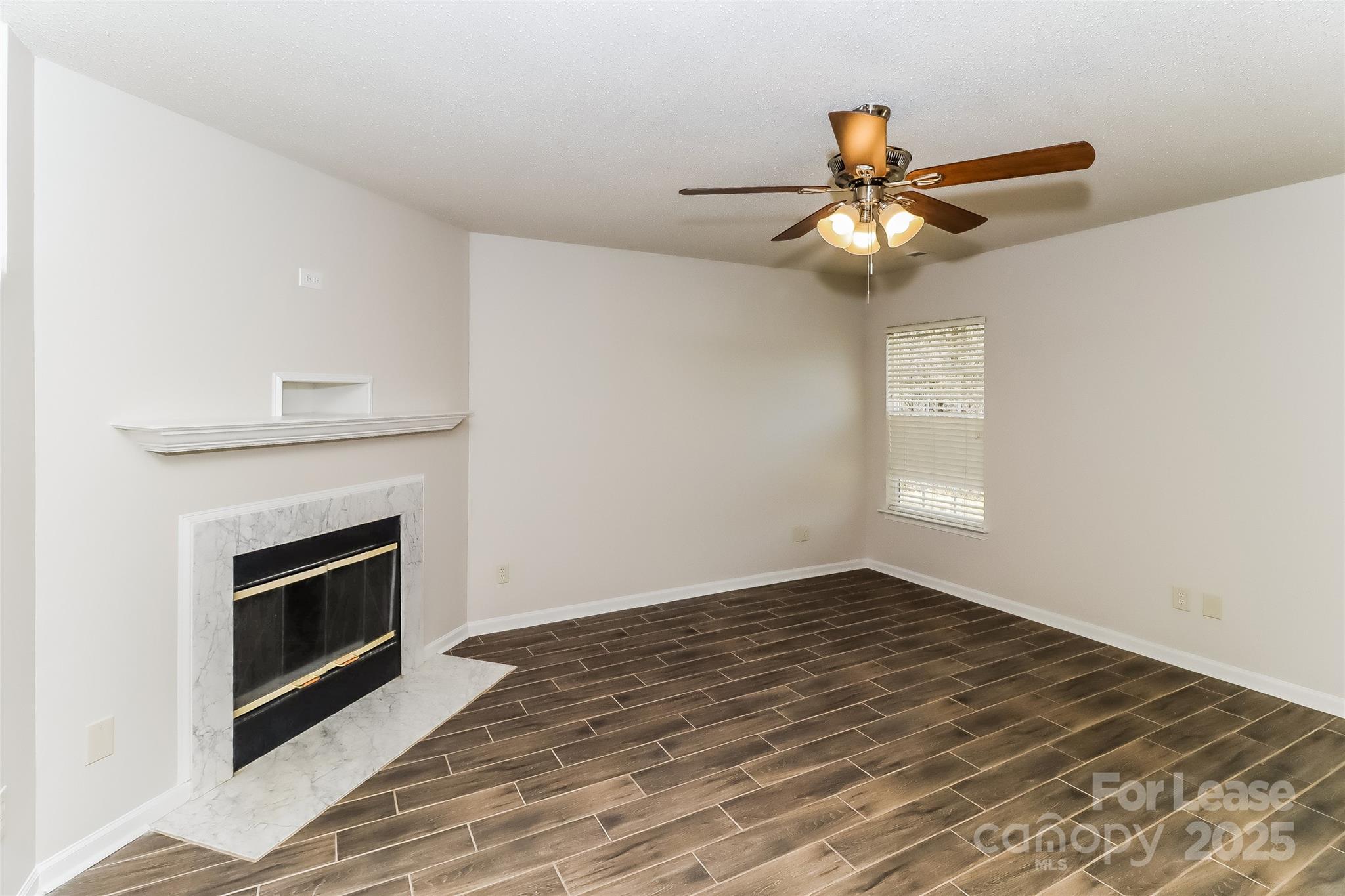2032 Pimpernel Road Charlotte, NC 28213 - Photo 4 of 17 a view of an empty room with window and chandelier fan