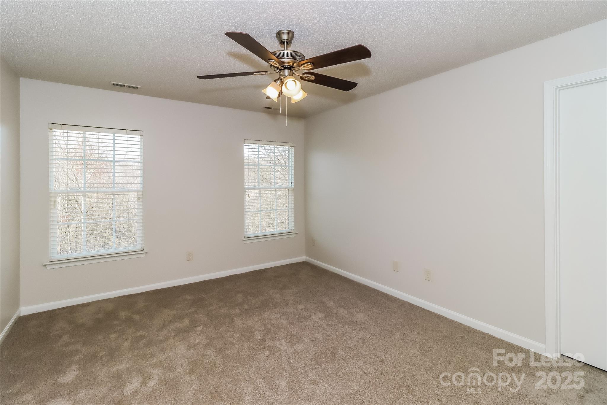 2032 Pimpernel Road Charlotte, NC 28213 - Photo 9 of 17 an empty room with windows and fan