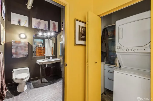 a bathroom with a toilet sink and mirror