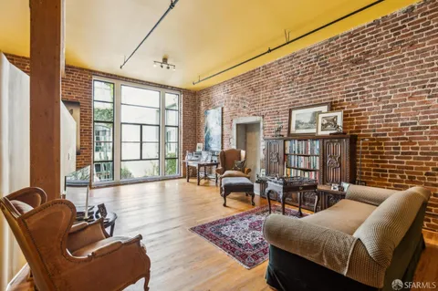 a living room with furniture and floor to ceiling windows